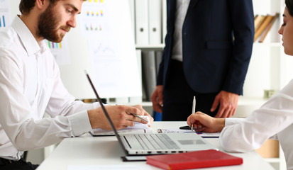 Group of people deliberate on white board problem