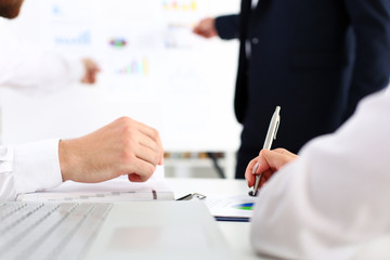 Group of people deliberate on white board problem