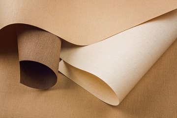 Abstract backgroud of rolled textured paper sheets of different shades