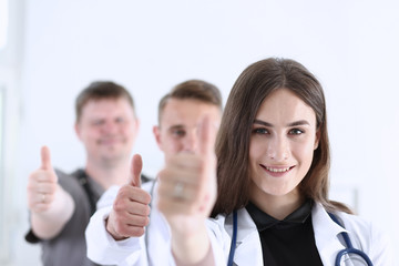 Group of doctor show OK or approval sign with thumb up