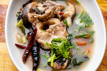 Tom Yum Snakehead Fish,Tom Yum Snakehead fish on Thai tableware In a bowl on a white ground for design in Thai food concept