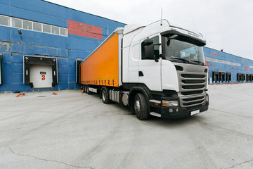 truck with a trailer at the warehouse