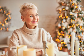 Xmas, holidays, decor, party and festive atmosphere concept. Good looking cheerful middle aged...