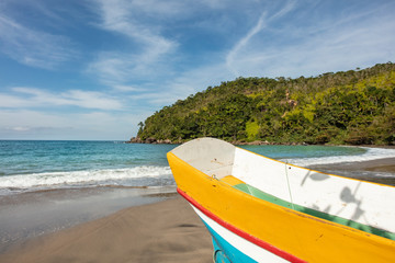 Fishing colorful boat at Castelhanos beach in Ilhabela, tropical island in secluded paradise on the tropical coast of Sao Paulo in Brazil