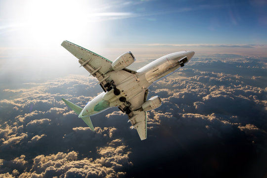 Passenger plane flies high above the clouds