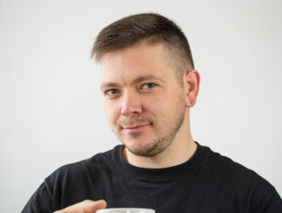 Happy man having cup of coffee in kitchen. Refreshment and energy. Smiling man holds mug with hot drink. Inspired with cup of fresh coffee.