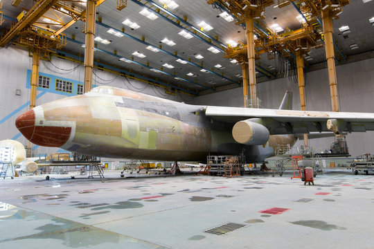 Modern cargo aircraft in the hangar during the heavy maintenance and painting