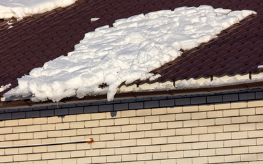 Brick house with snow on the roof