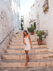 woman walking on the street going downstairs