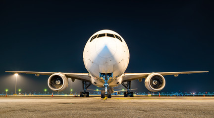 aircraft parking at gate in night