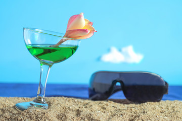 Summer day with cool cocktail on sea beach.