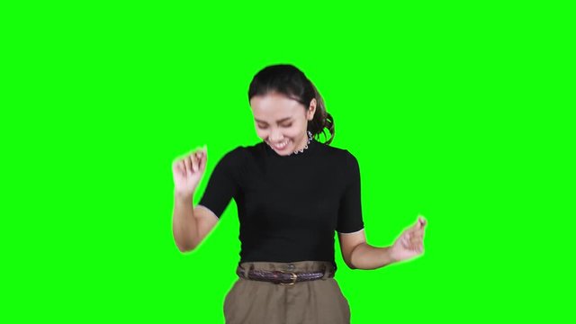 Beautiful teenage girl dancing in the studio with green screen background. Shot in 4k resolution