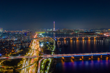 Fototapeta na wymiar Aerial view of Seoul downtown city skyline with light trails on expressway and bridge cross over Han river at night in Seoul city, South Korea.