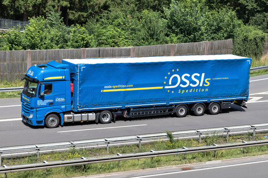 WIEHL, GERMANY - JUNE 24, 2019: Ossis Mercedes-Benz Actros truck with tarpaulin trailer on motorway.