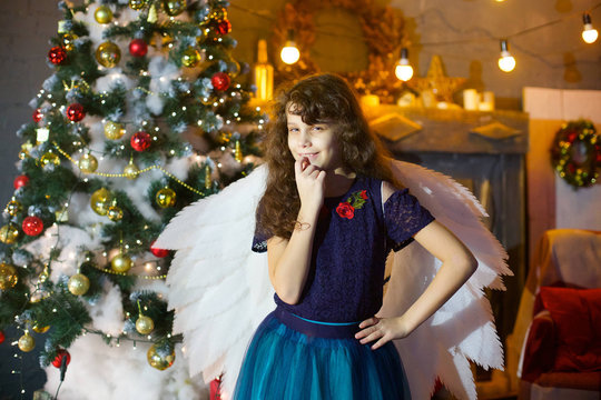 Girl in a blue dress with white wings