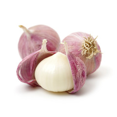 Garlic press and garlic on white background 