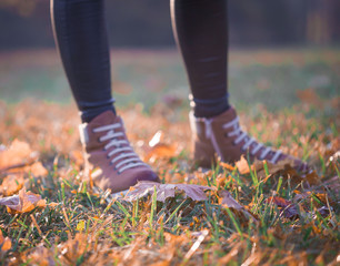 Woman legs boots in autumn nature