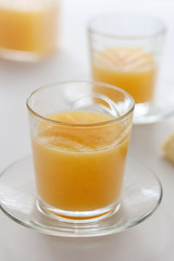 Two glasses of refreshing orange juice on a white table