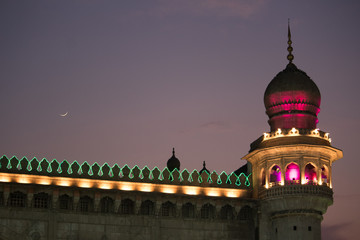Fototapeta na wymiar Scintillating view of Mecca Masjid (Mosque) near Charminar with crescent moon at night time