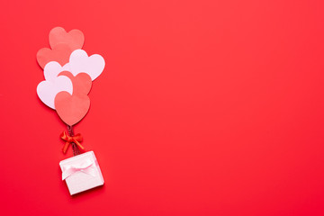 Valentine's day background with red and pink hearts like balloons on pink background, flat lay - obrazy, fototapety, plakaty