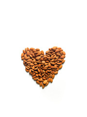 Almonds with different shape and coloured backdrop.