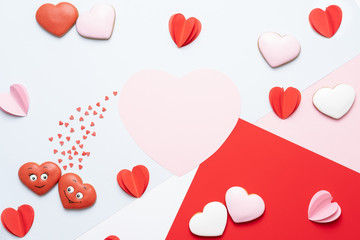 Valentines Day background with cookies, red and pink hearts on pastel background