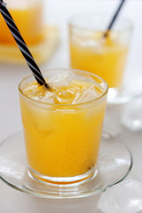 Two glasses of refreshing orange juice on a white table