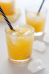 Two glasses of refreshing orange juice on a white table