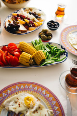 Delicious traditional turkish breakfast on table, with corn and other vegetables