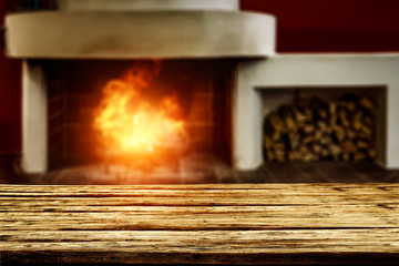 Table background of free space and home interior with fireplace 