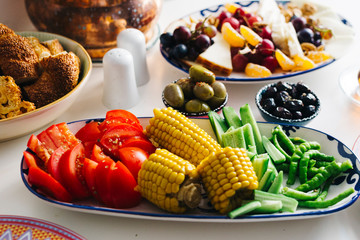Delicious traditional turkish breakfast on table, with corn and other vegetables