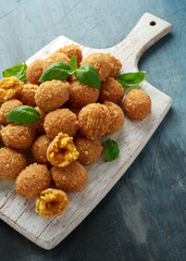 Fried Rice Balls with sweet hot sauce on wooden white board