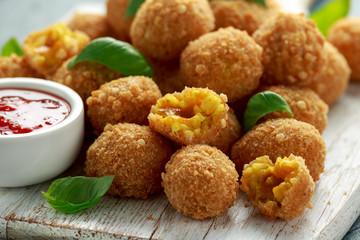 Fried Rice Balls with sweet hot sauce on wooden white board