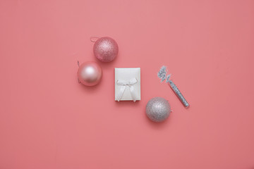 Top view of pink background with balls and gist box. Present for christmas or new year. copy space