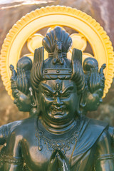 Green bronze statue of the Japanese Buddhist deity animal protector Bato Kannon with a horse head on the skull.