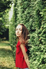 Young pretty girl's portrait on parkland background