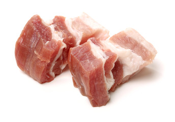 Raw pork belly pieces on a white background