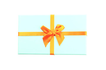 Christmas gift box blue. Orange ribbon. White background. Top view.