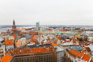Fototapeta na wymiar Panorama view from Riga cathedral on old town of Riga, Latvia. Beautiful aerial view of the Riga city centre. View of the roofs of the old town from above. Winter season in Riga, Latvia.
