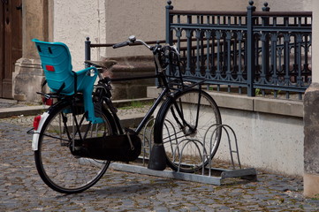 Fototapeta na wymiar Bike with child seat in a bicycle parking lot.