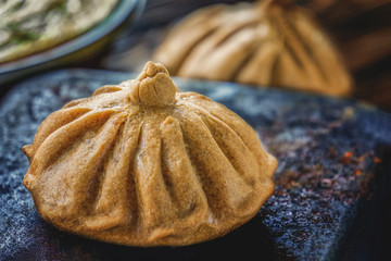 Buns of rye flour lie on a dark textured background. Homemade cake. Mexican day of dead bread, pan...