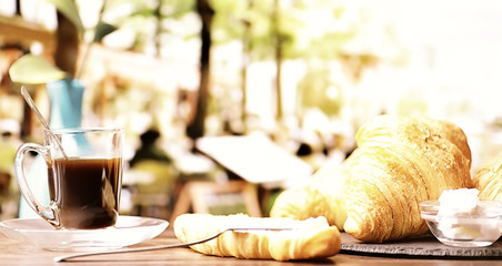 Fresh pastries on the table. French flavored croissant and coffee.