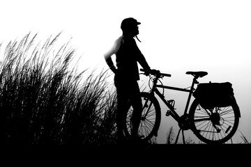 Fototapeta na wymiar Black on a white background Touring cyclist Vintage bicycles are parked in the midst of grasslands and sunsets in the evening.