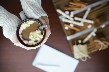 Winter breakfast. A cup of hot chocolate with marshmallows and freshly baked cookies. Gingerbread cookie and coffee.