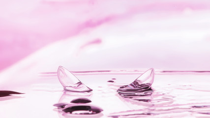 Tools for vision correction. Glasses and lenses with diopters on the background of splashes and...