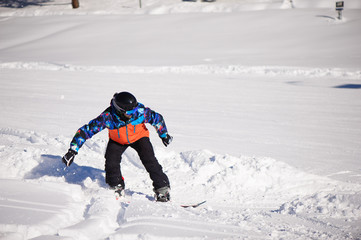 Fototapeta na wymiar Snowboarder silhouette in ski resort, skiing in the mountains