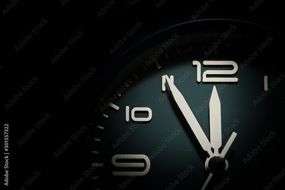Wall mural dial of a clock showing five minutes to twelve