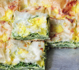 Spinach pie in a casserole with cheese and eggs