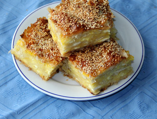 Homemade pie with cheese and eggs sprinkled with sesame seeds