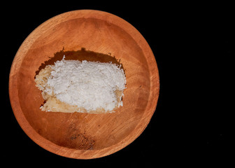 a indonesian food with sticky rice and banana on wood plate isolated black background